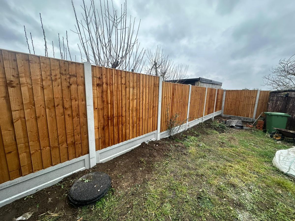 A long run of new closeboard fencing on concrete posts and gravel boards