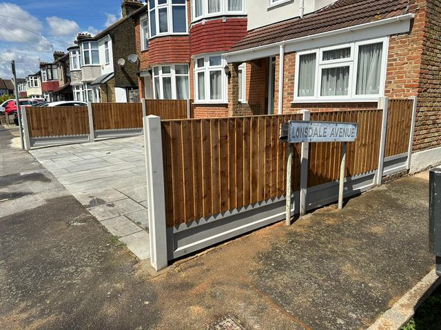 New closeboard fencing on concrete posts around a paved front garden