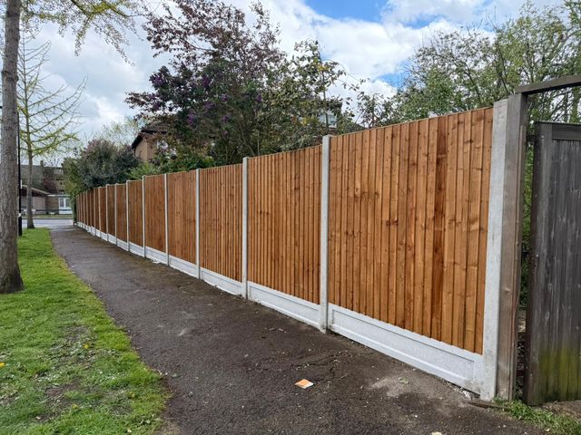 New closeboard fencing on concrete posts running along a public footpath