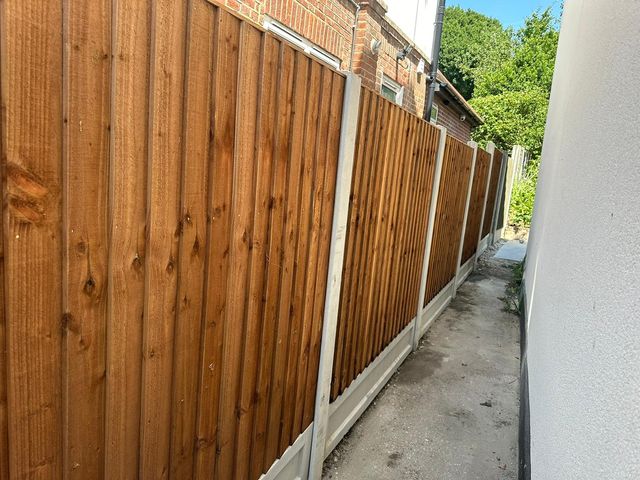 New closeboard panels on concrete posts running down a long side passage