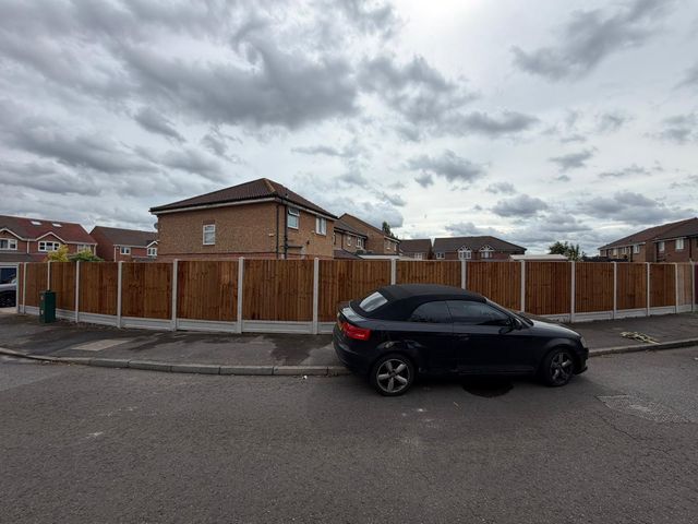 A long run of new closeboard fencing along a residential street corner